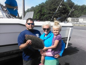 HERE IS MISS CADEE FIRST FLOUNDER.